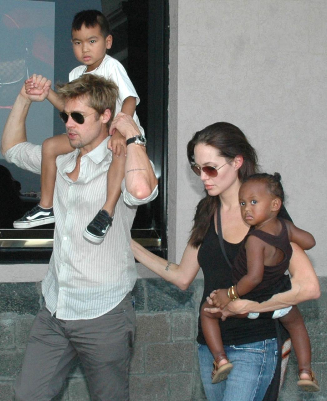 Angelina Jolie (right) with daughter Zahara and Brad Pitt (left) with son Maddox walk near the Gateway of India, in Mumbai, India, in 2006. Photo: AP