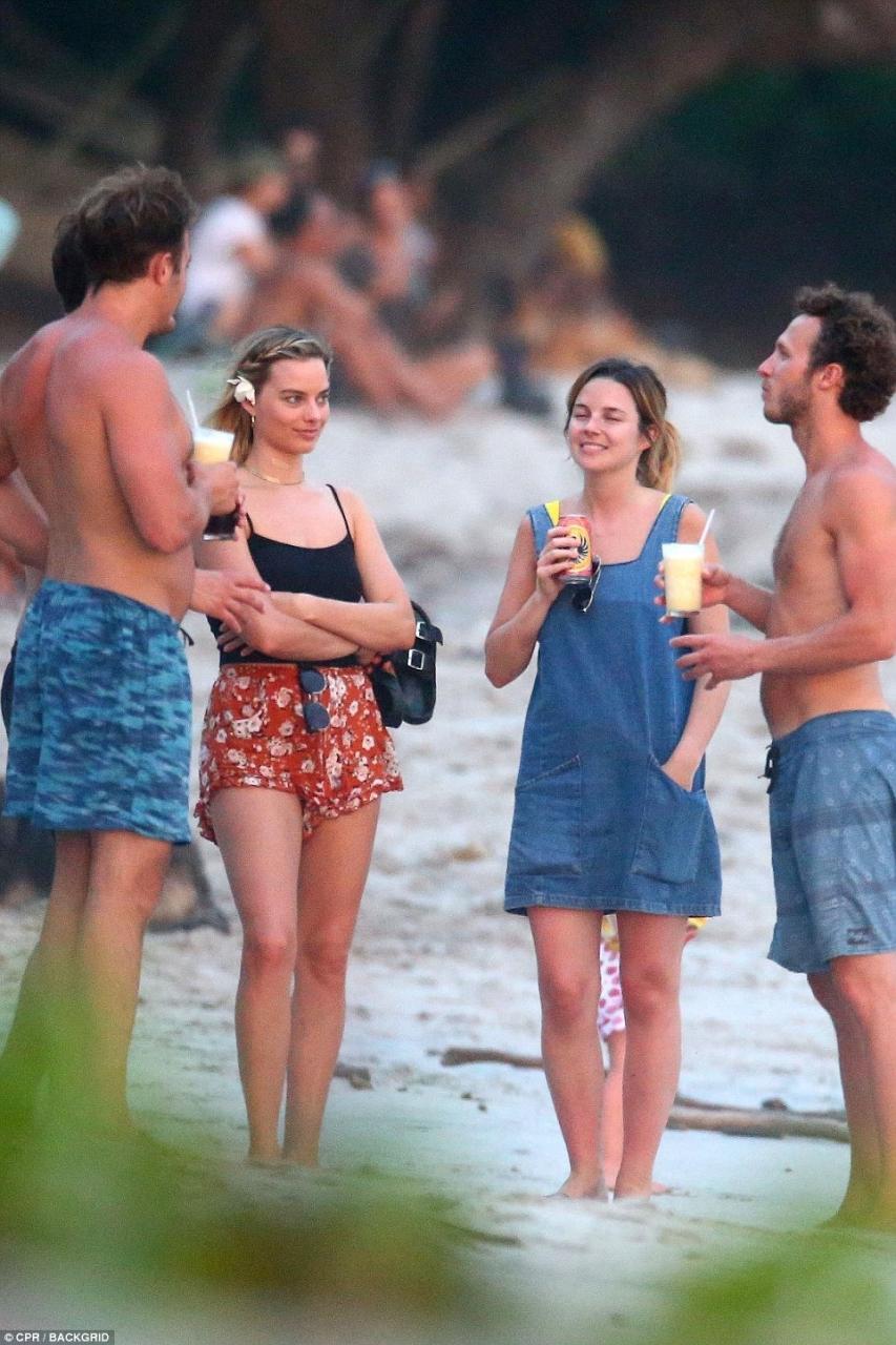 The perfect vacation: The group stood on the clear white sands after their day surfing and sunbathing