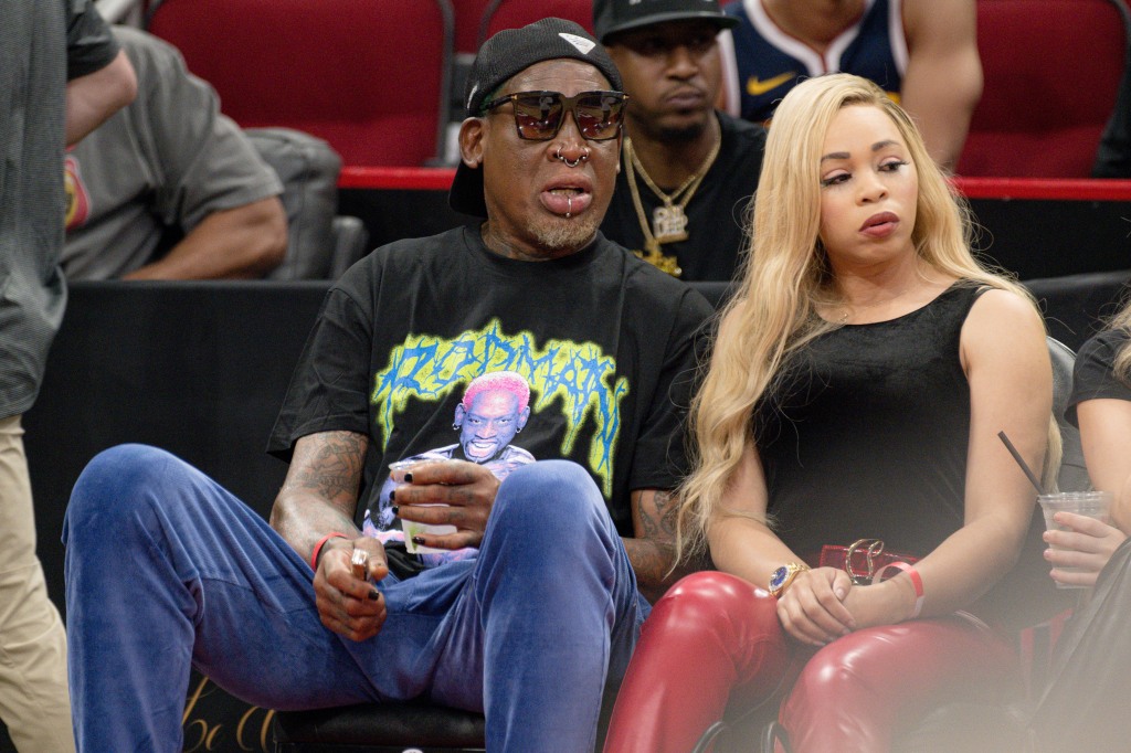 Dennis Rodman (l.) attends the Rockets-Nuggets game in Houston on April 4, 2023.