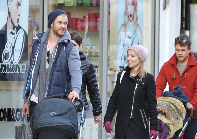 On dad duties: Chris Hemsworth trades his hammer for the pram as he enjoys a day out with wife Elsa Pataky and their daughter India Rose