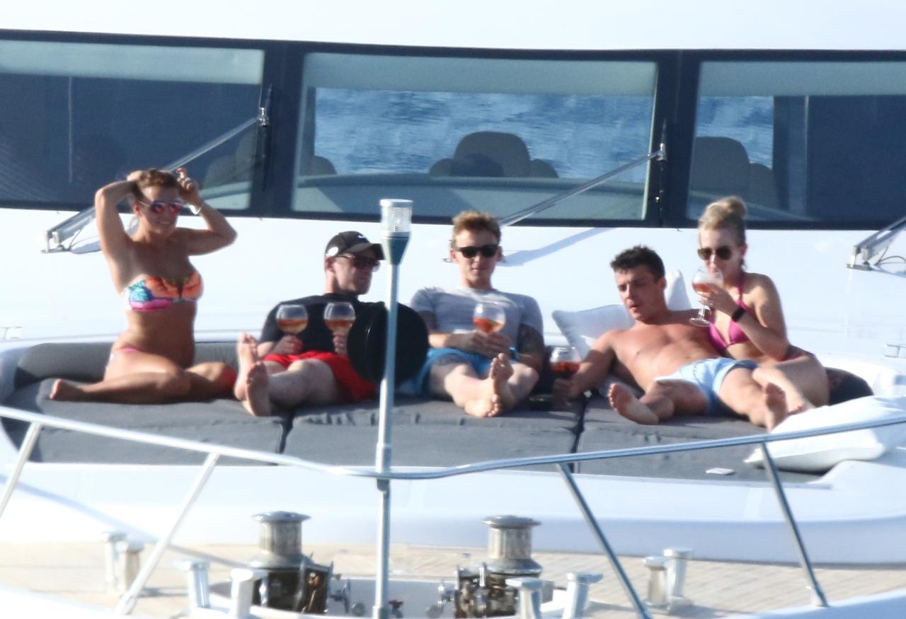 Wayne has a couple of goldfish Ƅowl sized wines in his hand as he sits on Ƅoard his yacht